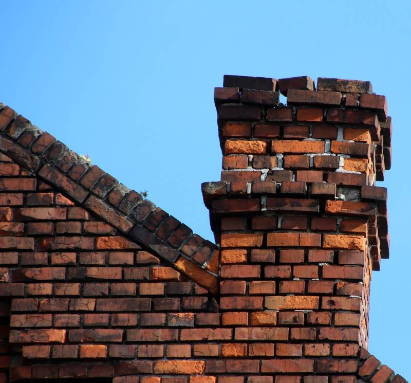 Signs Your Elkridge Home Needs a Chimney Inspection Damaged chimney on an Elkridge home showing cracks and missing mortar